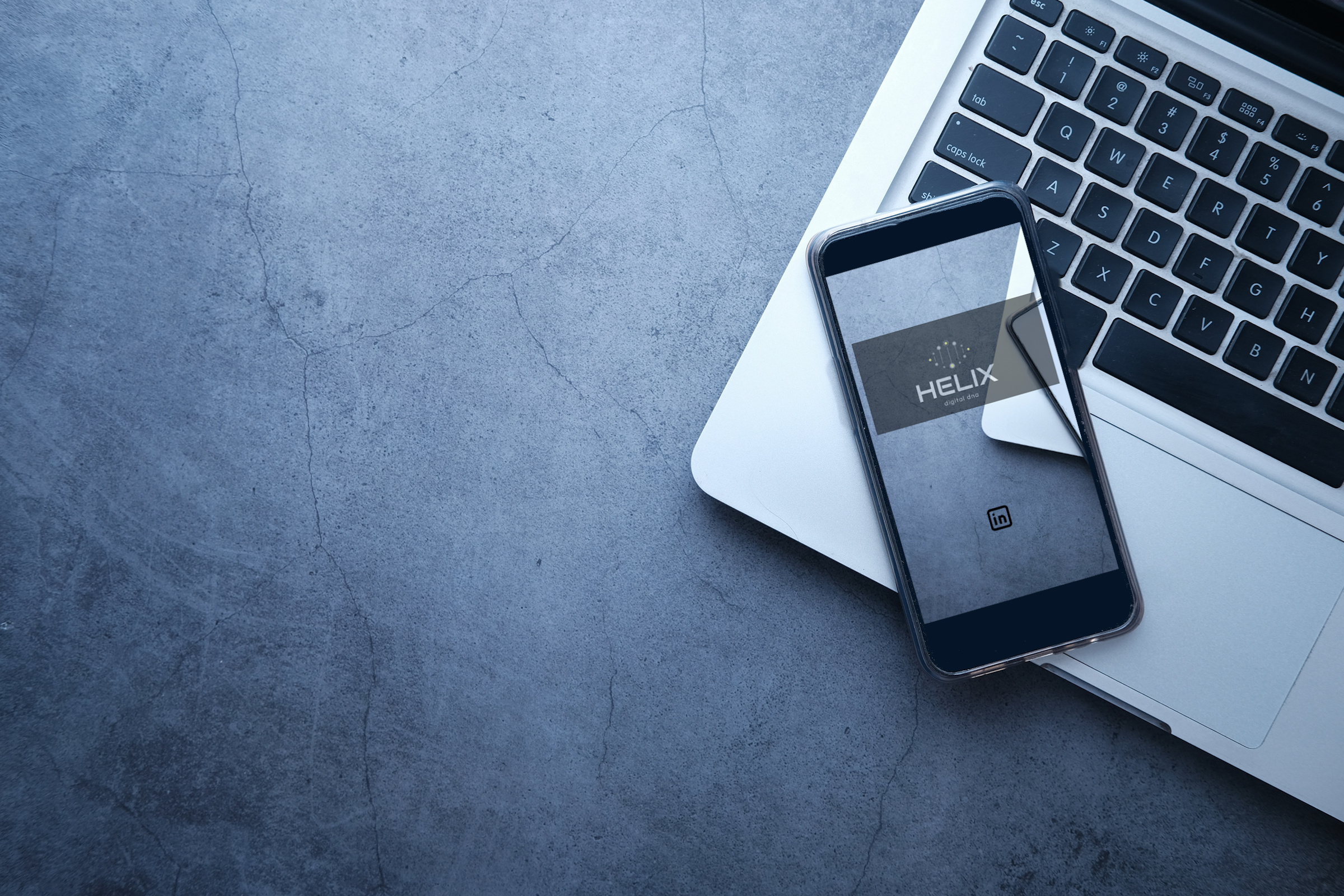 Top View of Smart Phone with Empty Screen and Laptop on Gray Background